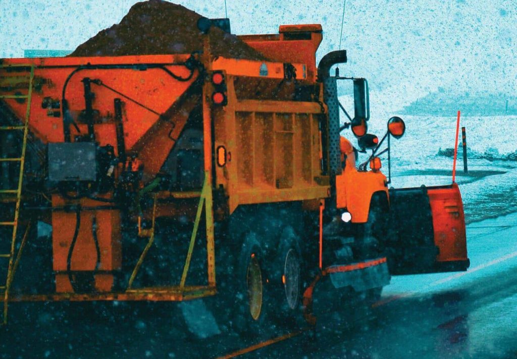 Snow plow operating in the winter