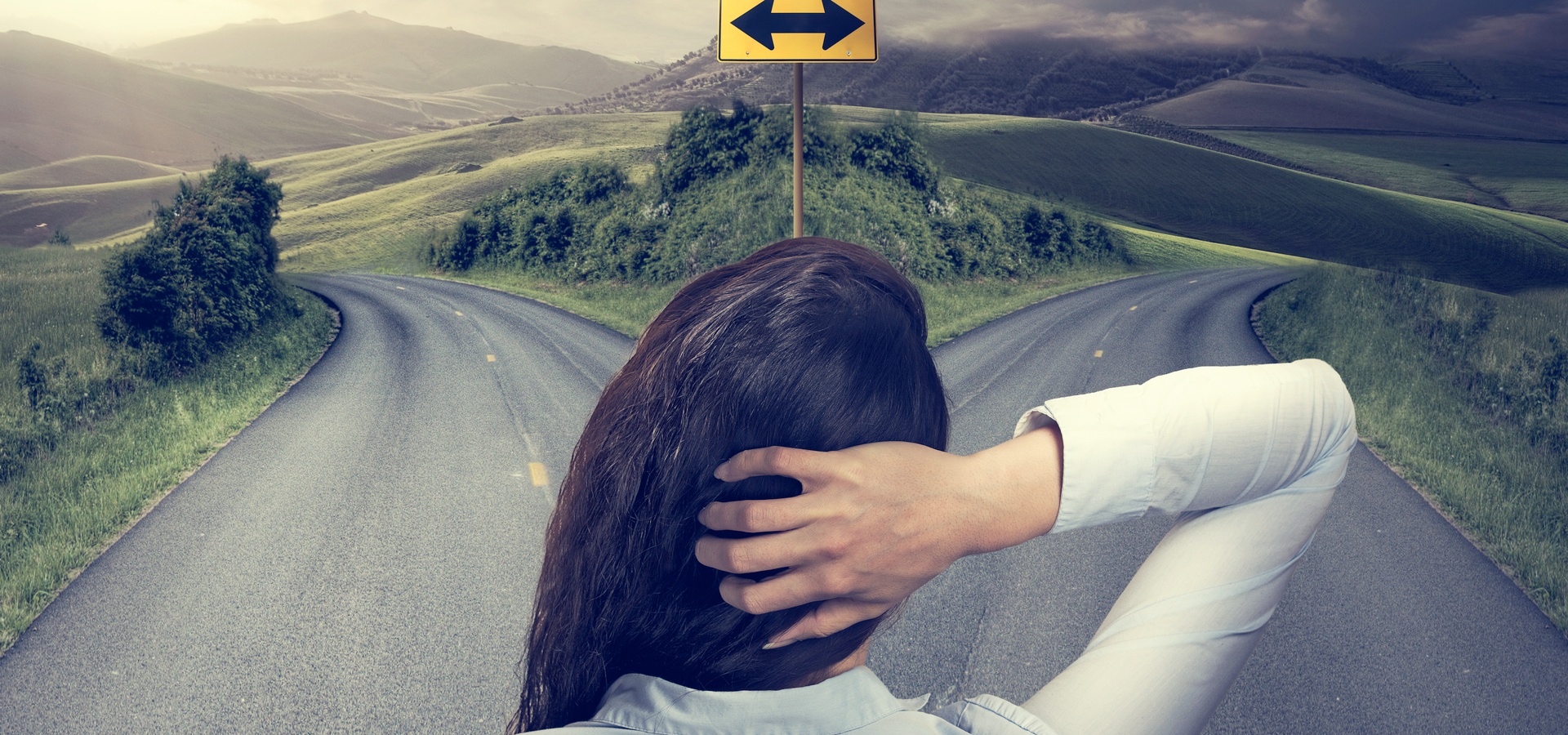 Woman trying to decide which road to take - left or right