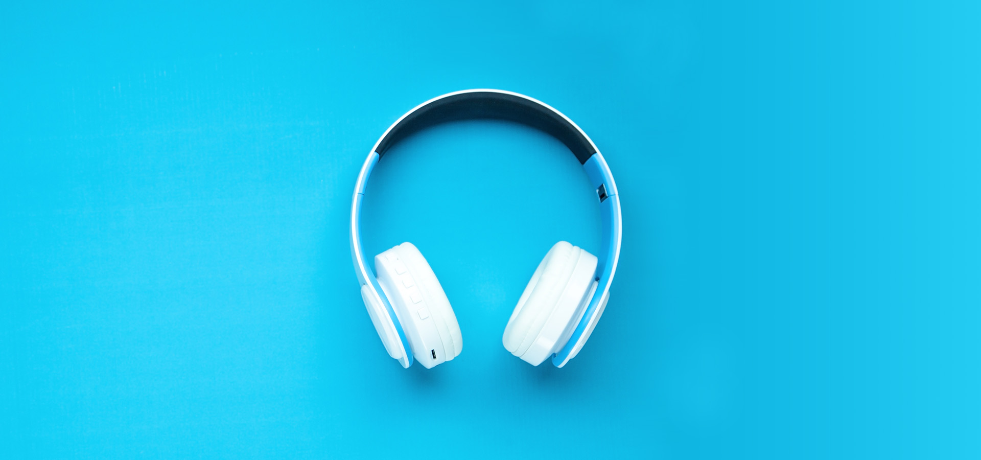 White headphones on a blue background.
