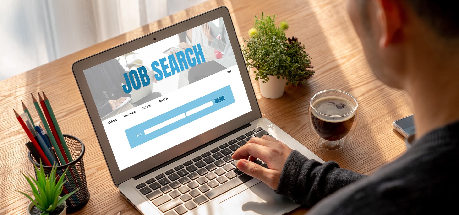 User browsing a careers page and job listings on a laptop during a job search