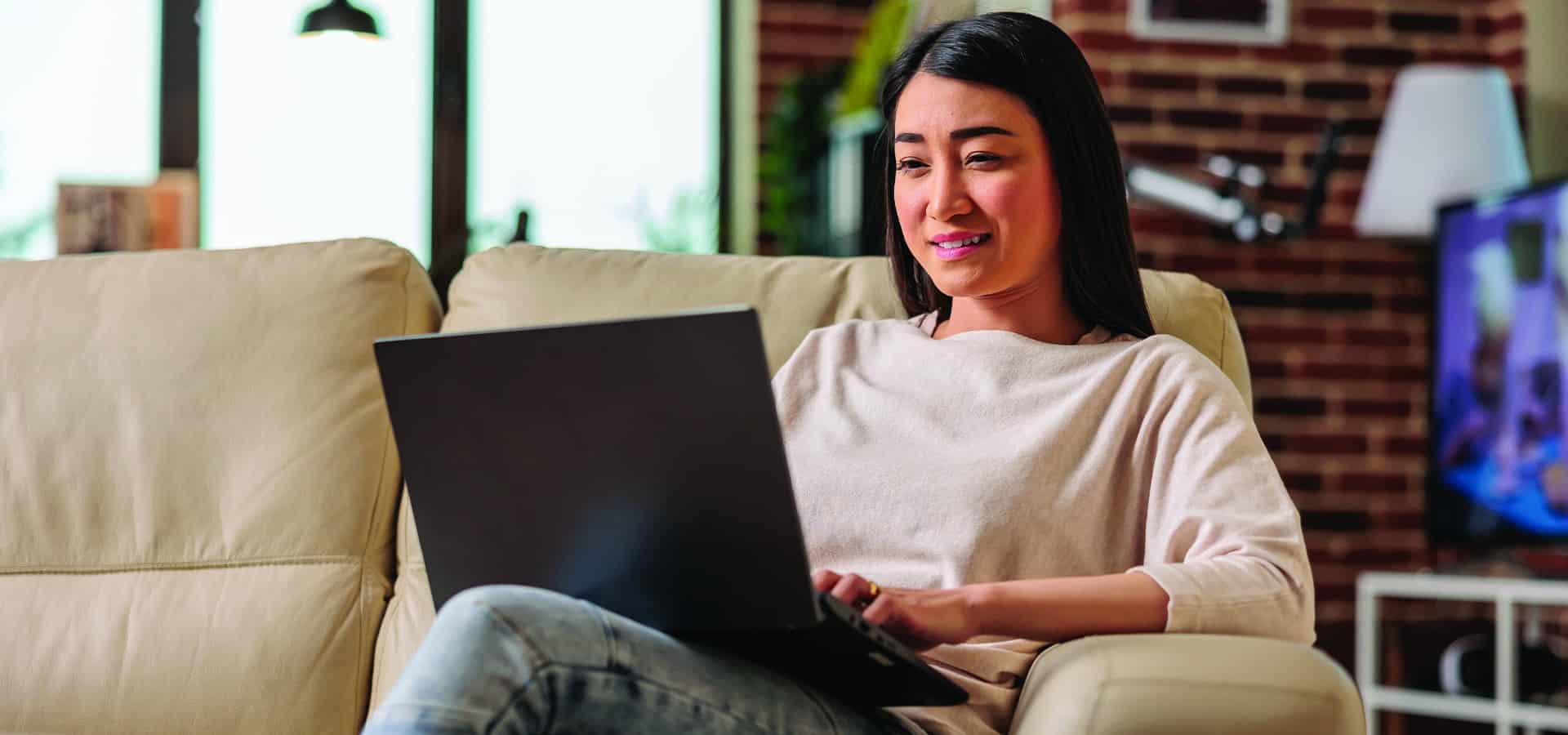 A woman searches for a job on her laptop using AI for career research.