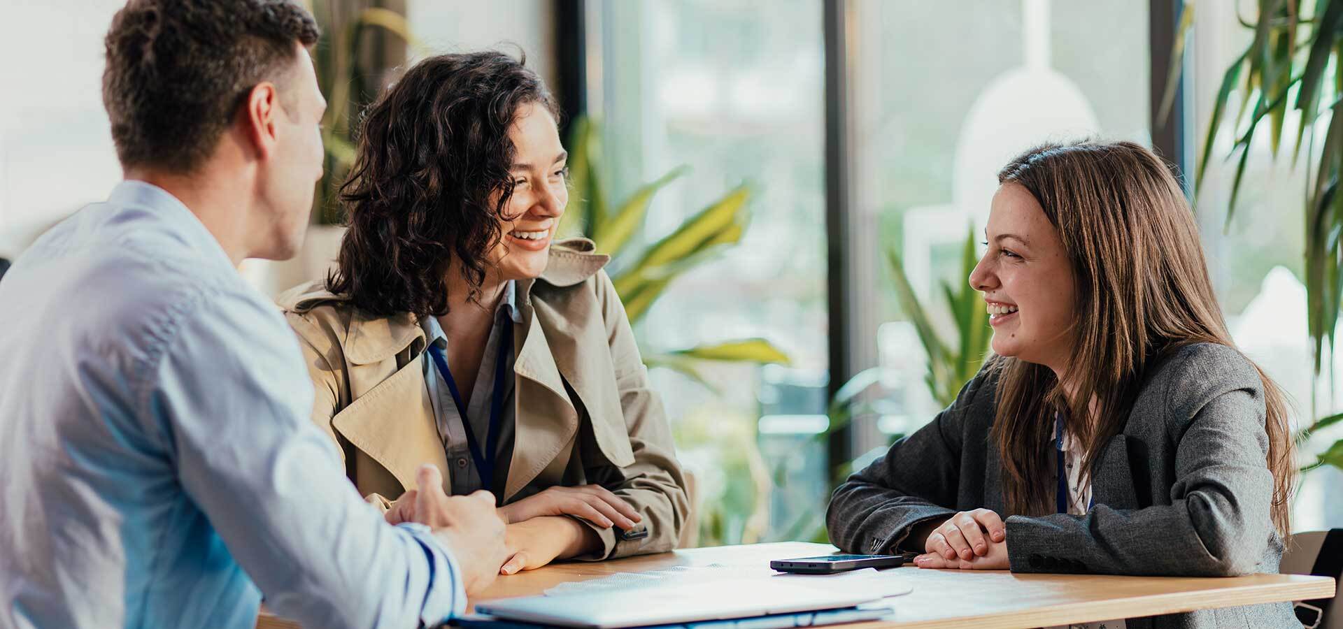A group shares stories of their work, building their EVP, around a break room table.